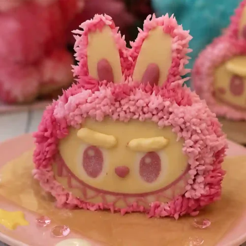 Close-up of a Labubu Cake with pink frosting and white chocolate face details