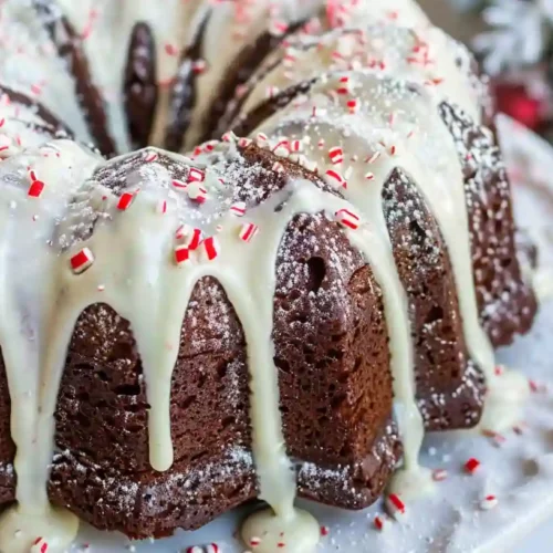 Chocolate Peppermint Bundt Cake with cream cheese frosting and crushed candy canes on top