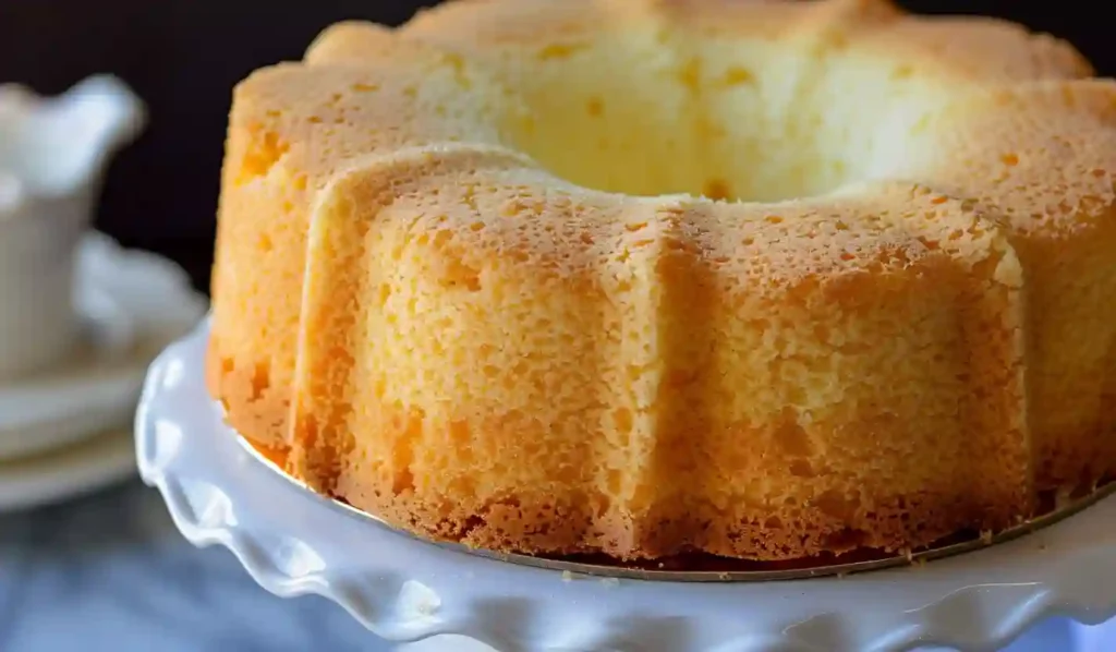 Homemade vanilla chiffon cake on a white cake stand, soft and fluffy texture