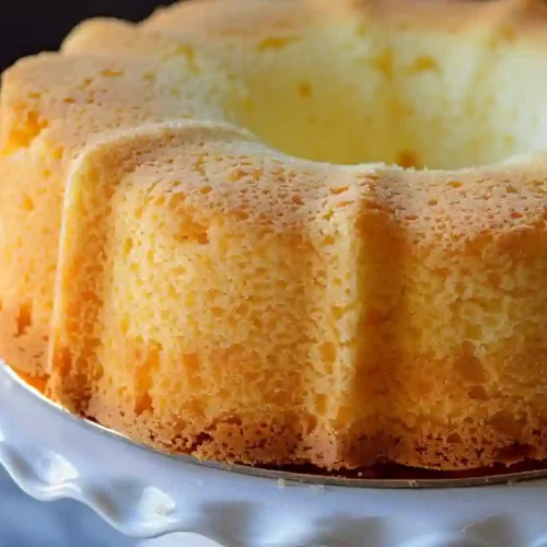 Homemade vanilla chiffon cake on a white cake stand, soft and fluffy texture