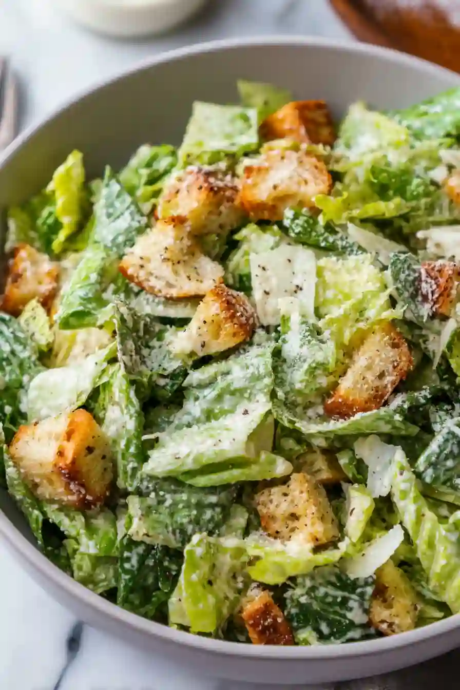 Cozy Caesar Salad with Creamy Homemade Dressing 2 Vertical close-up Caesar salad with romaine, croutons, and parmesan in a grey bowl