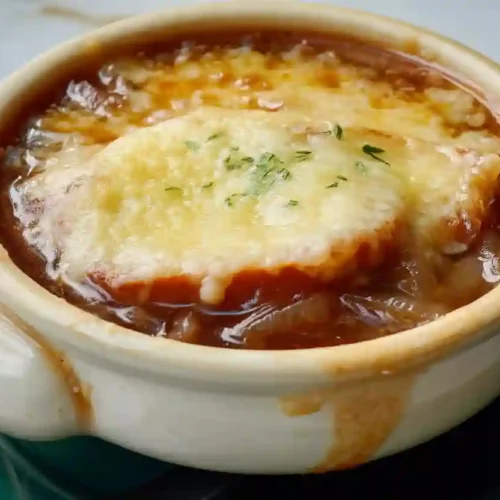 Cozy French Onion Soup for a Nourishing Family Dinner Night 3 Close-up of homemade French onion soup with caramelized onions and melted cheese topping in a ceramic bowl