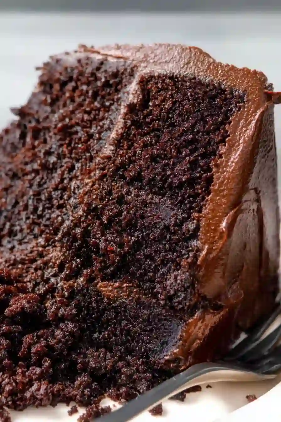 Dark Chocolate Cake for Cozy Celebrations and Comfort-Filled Nights 2 Vertical close-up image of moist dark chocolate cake with rich chocolate frosting