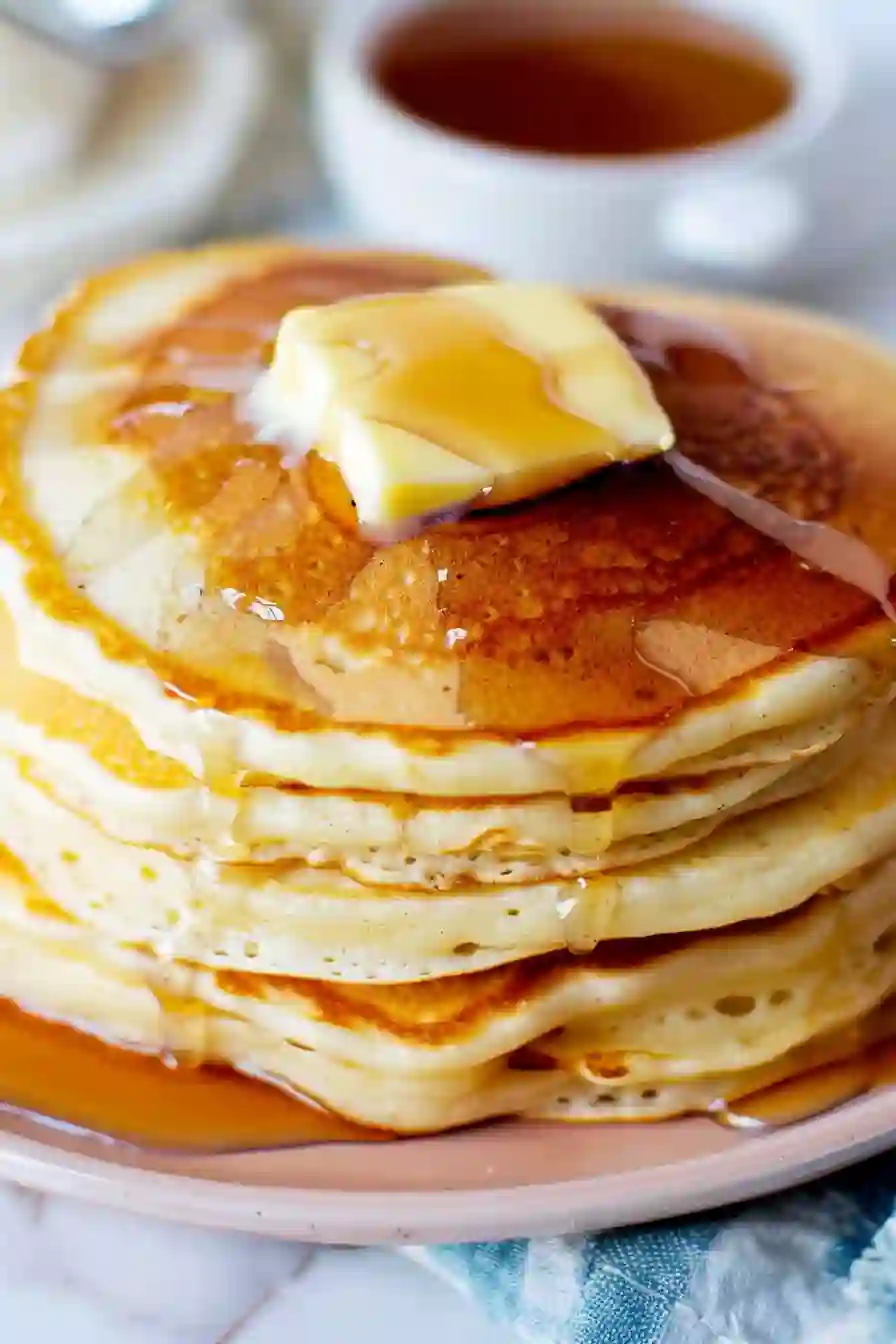 Fluffy pancake mix pancakes stacked with butter melting on top