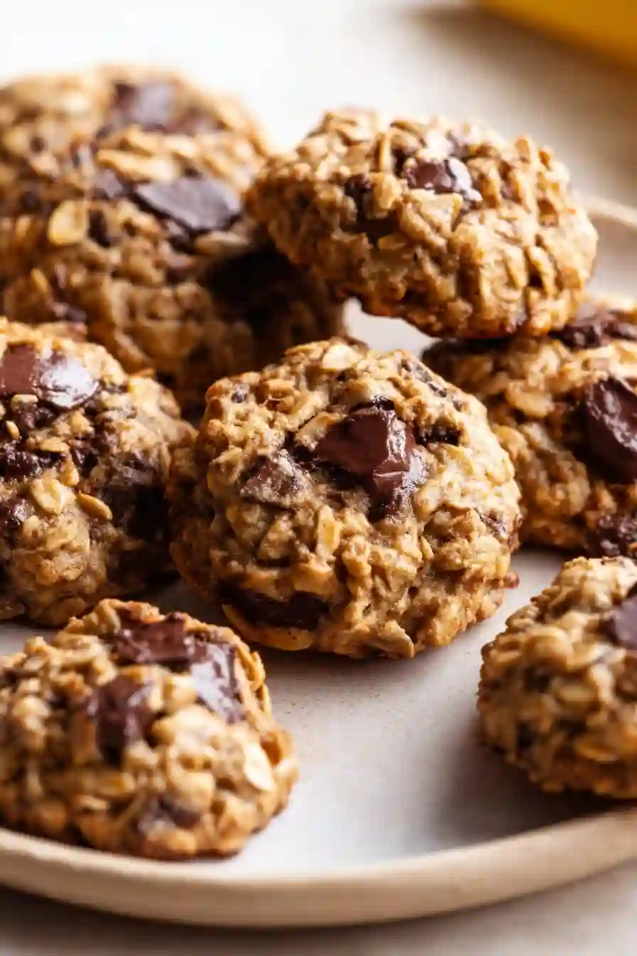 Vertical close-up of banana oatmeal cookies with chocolate chunks, soft baked texture