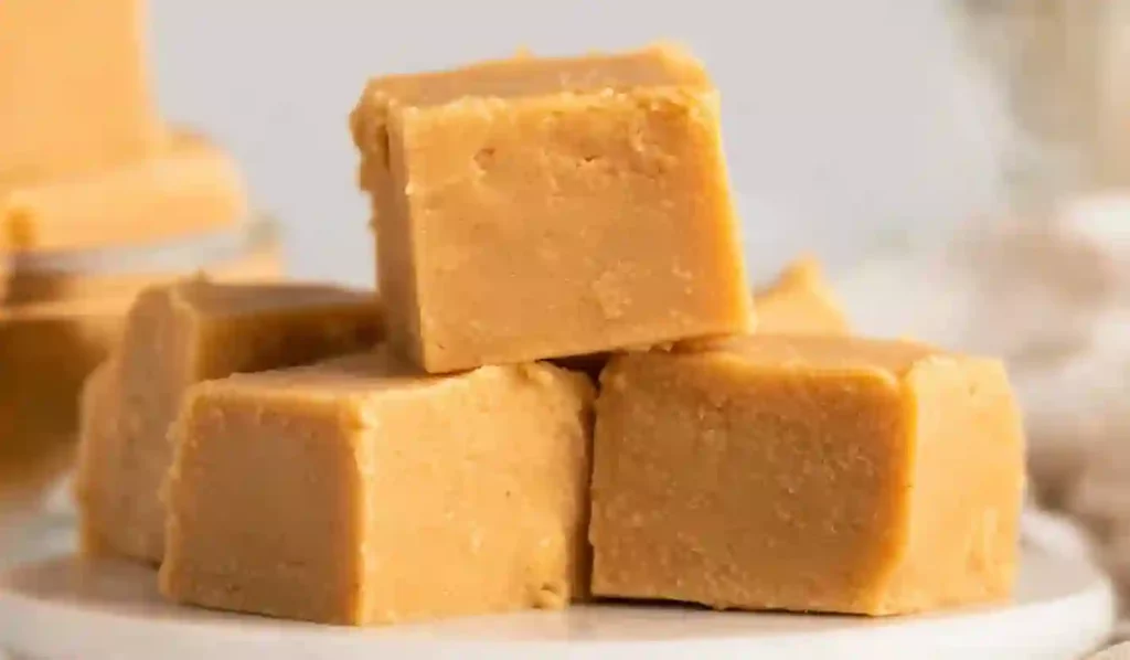 Extra close-up of creamy peanut butter fudge cubes stacked neatly on a clean surface