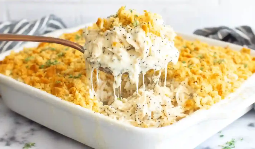 Extra close-up of creamy poppyseed chicken casserole with golden cracker topping in a glass baking dish