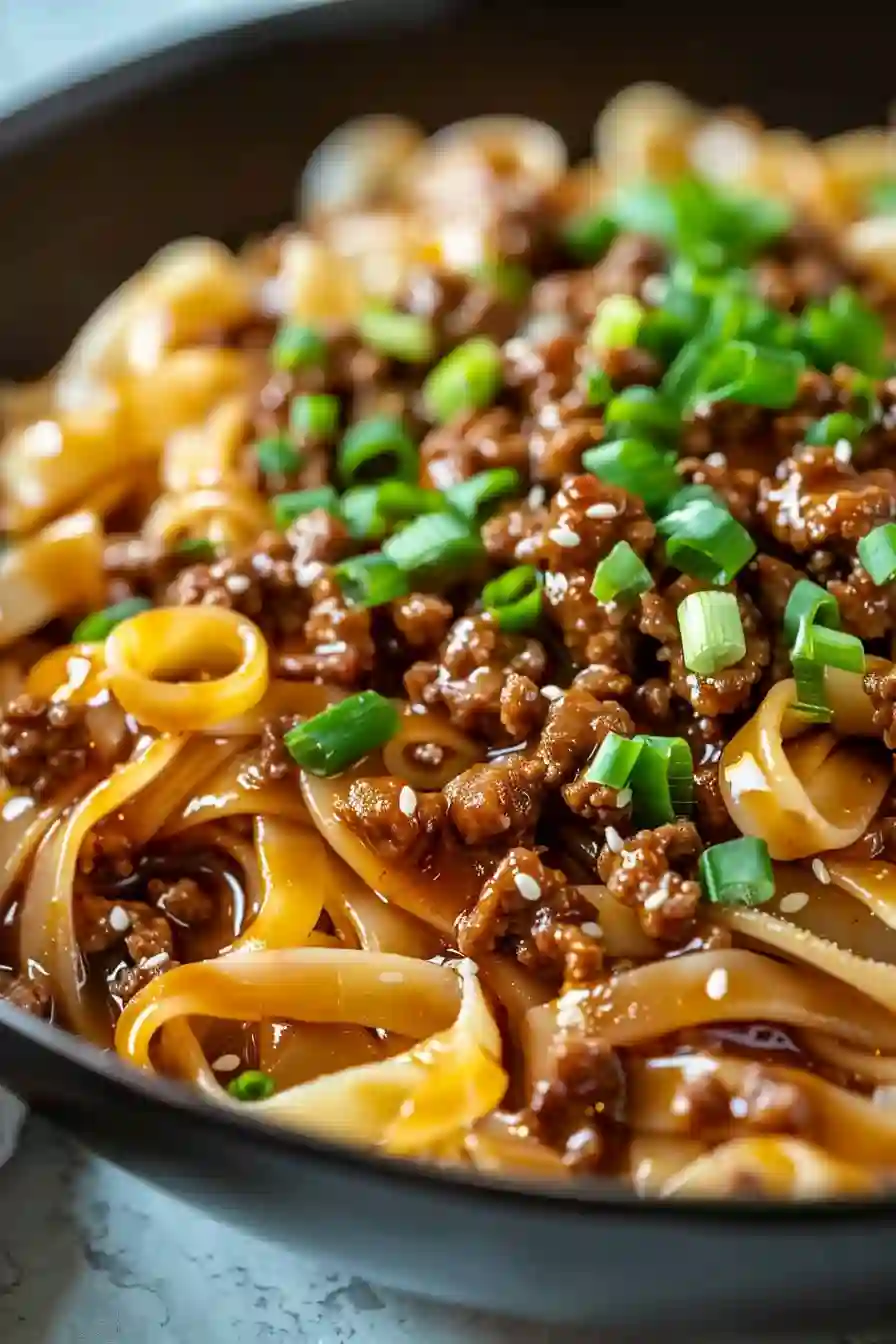 Mongolian Ground Beef Noodles – A Cozy, Protein-Packed Weeknight Favorite 2 Vertical close-up of Mongolian ground beef noodles with green onions in glossy sauce