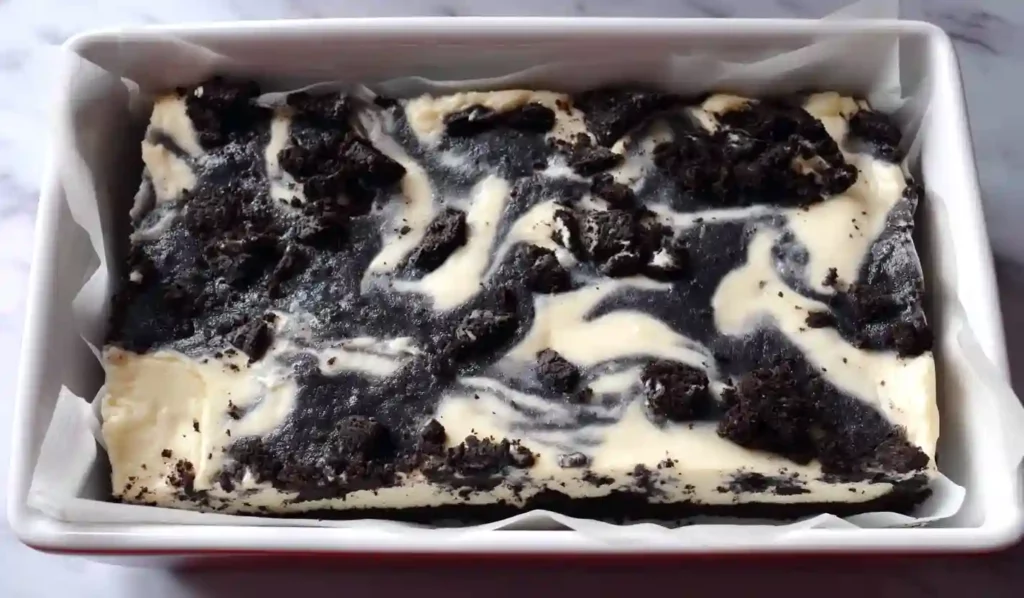 Extra close-up of keto Oreo cheesecake bars with crushed chocolate cookie topping and creamy cheesecake marbling