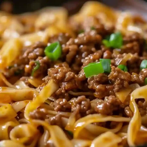 Mongolian Ground Beef Noodles – A Cozy, Protein-Packed Weeknight Favorite 3 Close-up of Mongolian ground beef noodles coated in glossy brown sauce with green onions