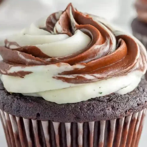 Close-up marble black and white cupcake with chocolate and vanilla swirled frosting