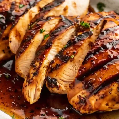 Juicy balsamic glazed chicken breasts with caramelized grill marks and glossy sauce
