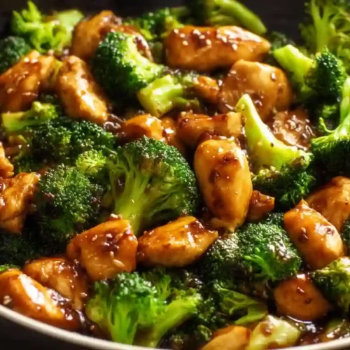 Chicken and Broccoli Stir Fry – A Cozy, Protein-Packed Weeknight Dinner 3 Close-up chicken and broccoli stir fry in glossy soy sauce in a dark pan