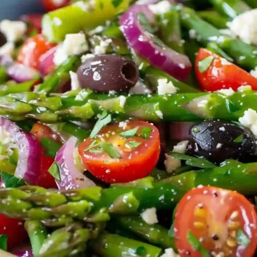 Italian Asparagus Salad – A Fresh, Cozy Mediterranean-Inspired Side 3 Close-up asparagus salad with cherry tomatoes, olives, red onion, and feta in a colored bowl