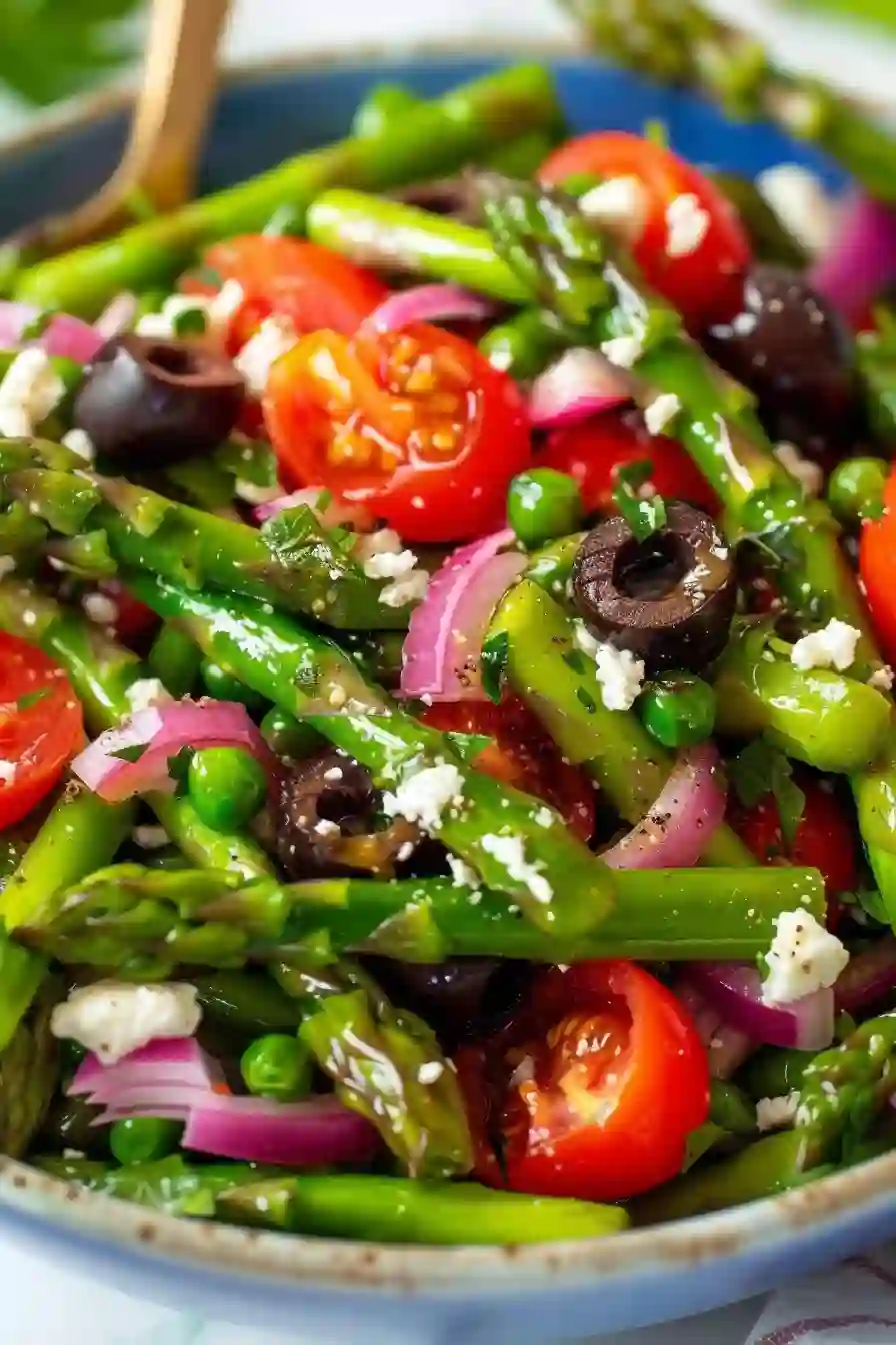 Italian Asparagus Salad – A Fresh, Cozy Mediterranean-Inspired Side 2 Vertical close-up of asparagus salad with tomatoes, olives, red onion, and feta in a blue bowl