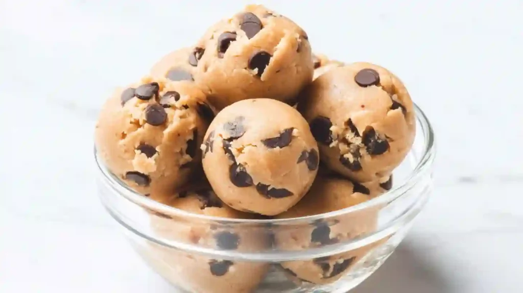 Close-up of Kodiak protein cookie dough bites with chocolate chips in a glass bowl