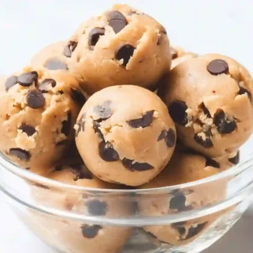 Close-up of Kodiak protein cookie dough bites with chocolate chips in a glass bowl