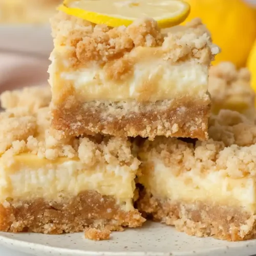 Close-up stacked lemon crumb bars with creamy lemon filling and golden crumble topping