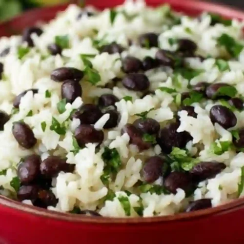 Close-up of cilantro lime rice mixed with black beans in a colorful bowl