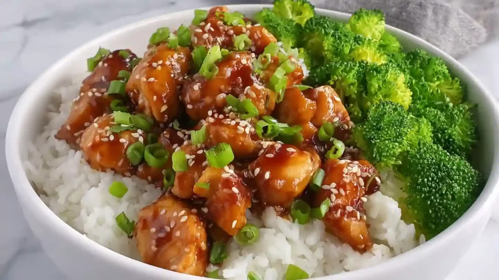 Close-up teriyaki chicken bowl with broccoli over white rice