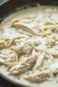 Shredded chicken mixed into creamy Alfredo parmesan sauce for lasagna filling