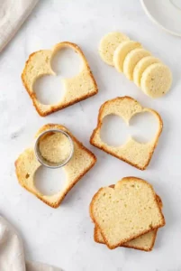 Cutting small round sponge cake circles for mini Victoria cakes
