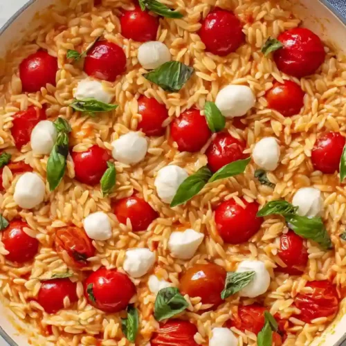Caprese Orzo 7 Creamy tomato caprese orzo with mozzarella pearls, basil, and cherry tomatoes