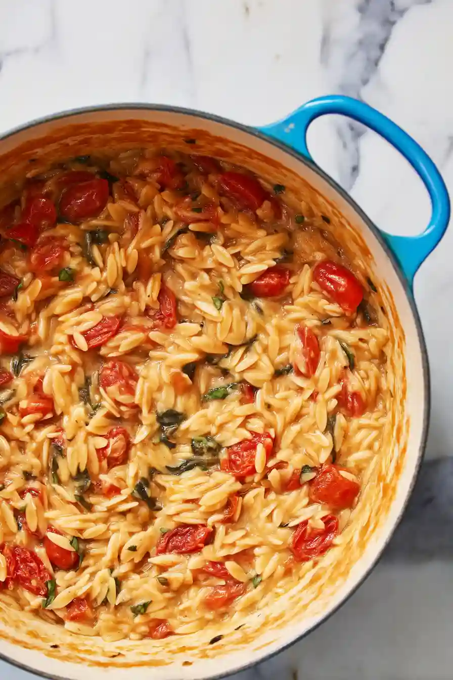 Caprese Orzo 5 Orzo simmering in tomato broth until tender with softened cherry tomatoes and basil.