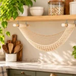 Crochet fruit hammock pattern displayed beneath a wooden kitchen shelf